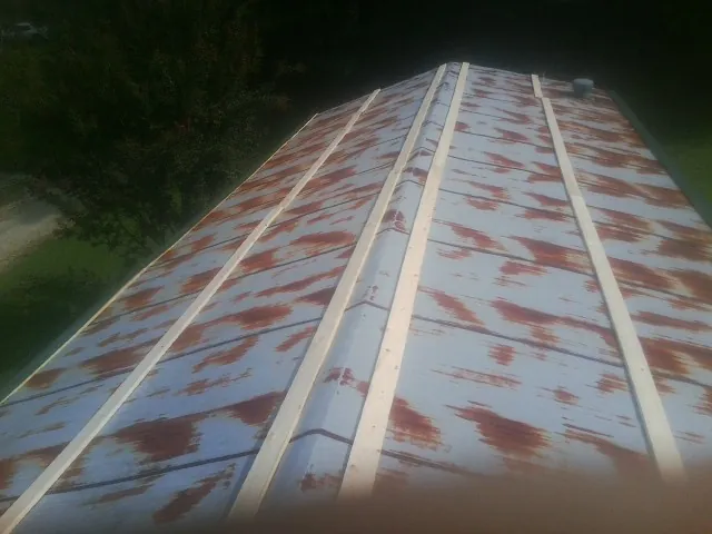 Rusted metal roof panels with new wood purlins before replacement — Storm Damage Roof Repair in Clementon by Roofing Brothers