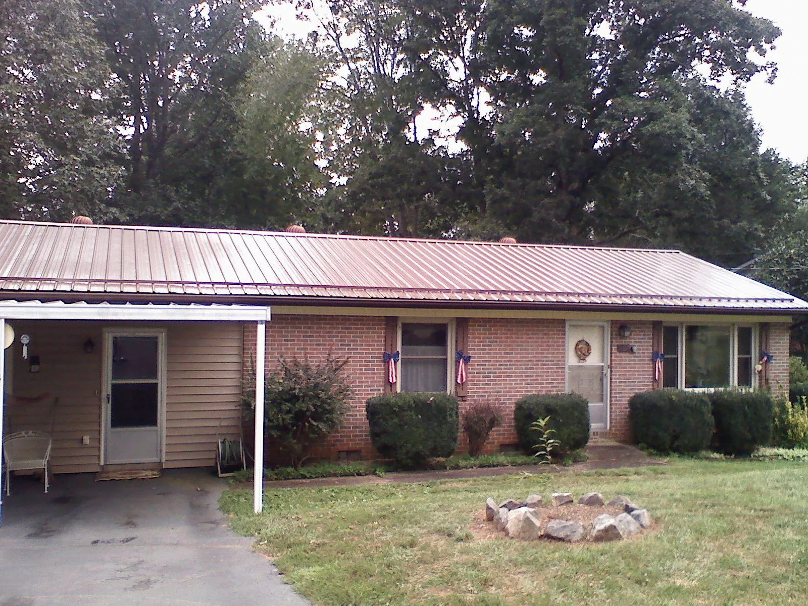 Bronze metal roof and carport on a brick ranch home — Roof Repair work by our crew in Clementon